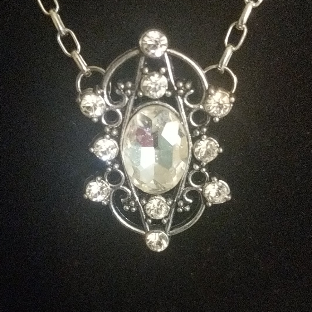 Unusual silver tone necklace with clear crystals